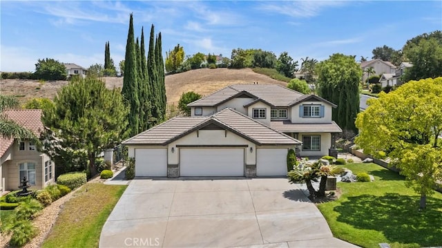 2504 Martingail Dr, Covina, CA 91724 - traditional home with stucco siding, concrete driveway, a garage, a front lawn, and a tiled roof