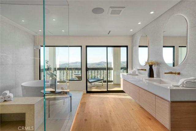 32075 Canterhill Pl, Westlake Village, CA 91361 - full bath featuring wood finished floors, a mountain view, double vanity, and a freestanding tub