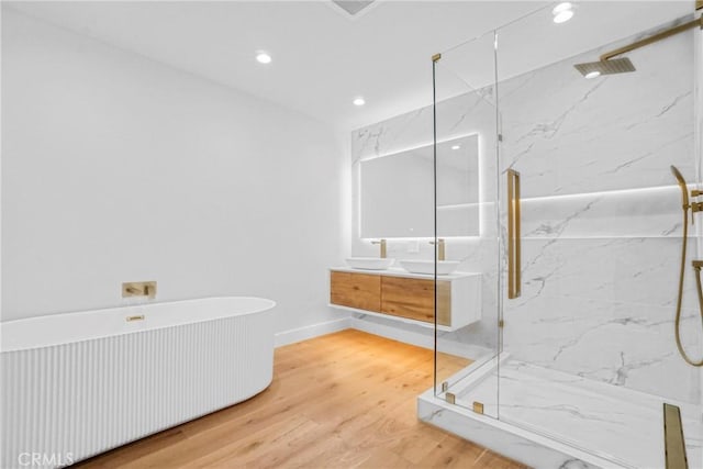 32075 Canterhill Pl, Westlake Village, CA 91361 - bathroom with a marble finish shower, double vanity, a soaking tub, wood finished floors, and recessed lighting
