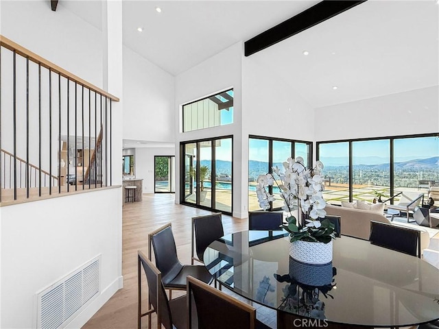 32075 Canterhill Pl, Westlake Village, CA 91361 - dining space with high vaulted ceiling, wood finished floors, beamed ceiling, plenty of natural light, and a mountain view