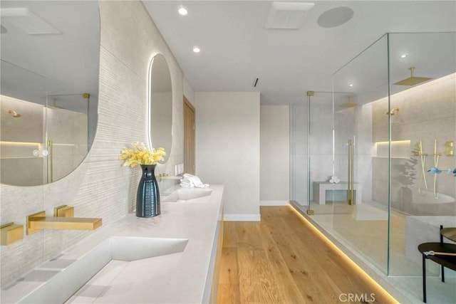 32075 Canterhill Pl, Westlake Village, CA 91361 - bathroom featuring wood finished floors, a stall shower, double vanity, and recessed lighting