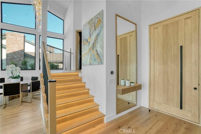 32075 Canterhill Pl, Westlake Village, CA 91361 - staircase featuring wood finished floors and a towering ceiling