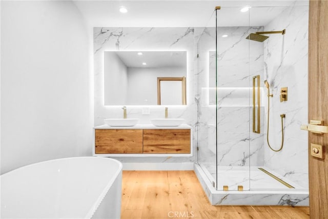 32075 Canterhill Pl, Westlake Village, CA 91361 - full bath with a marble finish shower, a freestanding bath, double vanity, wood finished floors, and recessed lighting