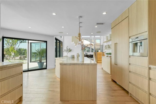 32075 Canterhill Pl, Westlake Village, CA 91361 - kitchen with light brown cabinets, a center island, modern cabinets, and recessed lighting