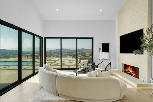 32075 Canterhill Pl, Westlake Village, CA 91361 - living room featuring wood finished floors, a lit fireplace, and recessed lighting