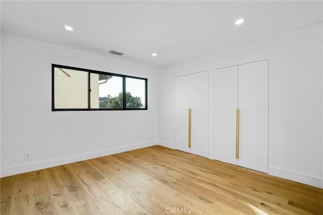 32075 Canterhill Pl, Westlake Village, CA 91361 - unfurnished bedroom with two closets, light wood-type flooring, and recessed lighting