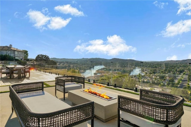 32075 Canterhill Pl, Westlake Village, CA 91361 - view of patio featuring a fire pit, a water and mountain view, and outdoor dining area