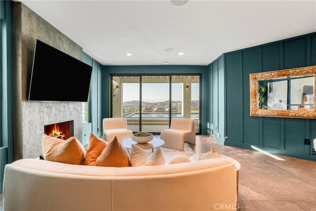 32075 Canterhill Pl, Westlake Village, CA 91361 - carpeted living area featuring a decorative wall, a lit fireplace, and recessed lighting