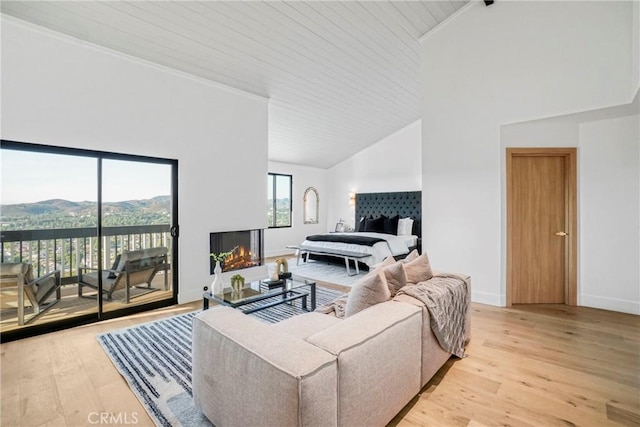 32075 Canterhill Pl, Westlake Village, CA 91361 - living room featuring high vaulted ceiling, light wood-type flooring, a multi sided fireplace, and wood ceiling