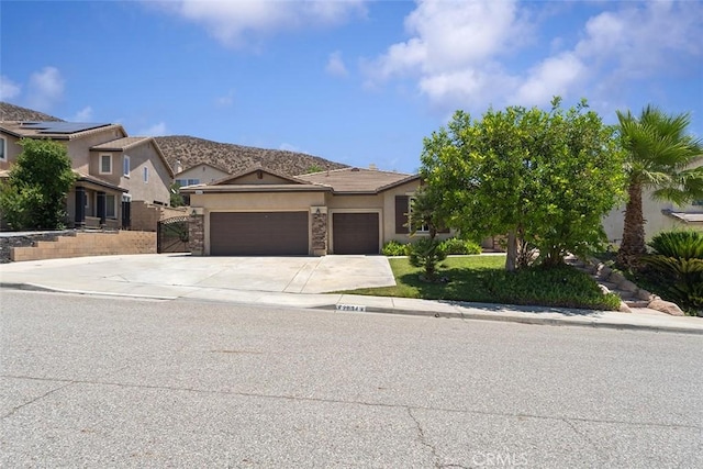 29184 Stone Ridge St, Menifee, CA 92584 - view of front of home with an attached garage, concrete driveway, and stucco siding