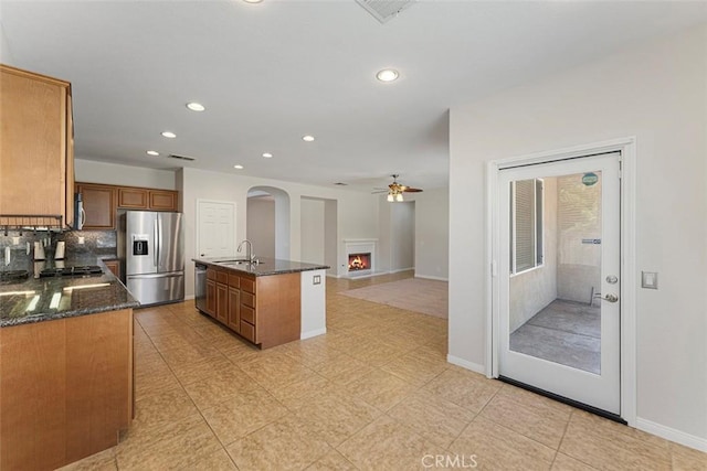 29184 Stone Ridge St, Menifee, CA 92584 - kitchen featuring stainless steel appliances, a ceiling fan, brown cabinets, recessed lighting, and arched walkways