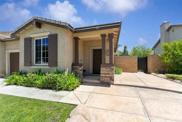 29184 Stone Ridge St, Menifee, CA 92584 - view of front facade with stucco siding and a gate