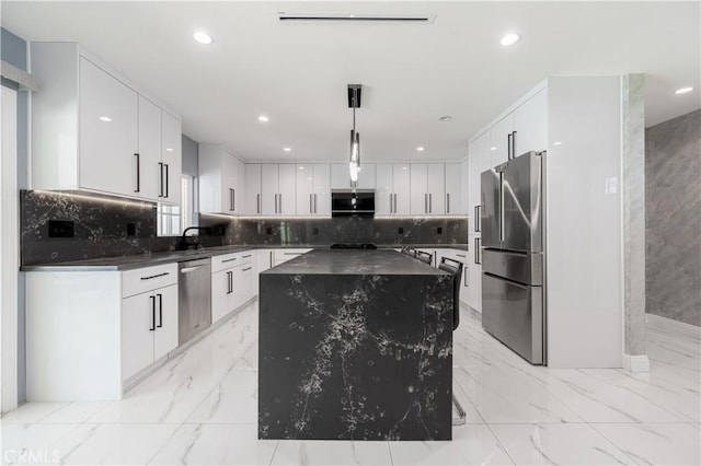 11118 Haskell Ave, Granada Hills, CA 91344 - kitchen with appliances with stainless steel finishes, dark countertops, light marble finish floors, a kitchen island, and recessed lighting