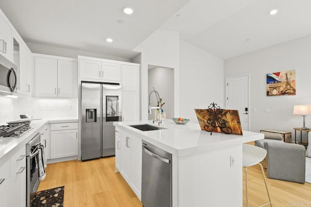 12639 Elizabeth Way, San Diego, CA 92129 - kitchen featuring appliances with stainless steel finishes, light wood-type flooring, white cabinetry, light countertops, and recessed lighting