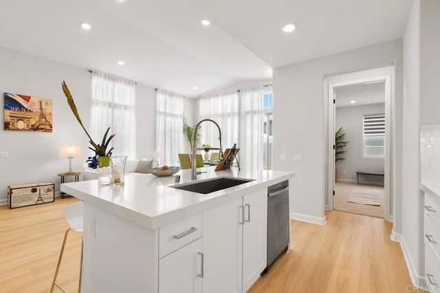 12639 Elizabeth Way, San Diego, CA 92129 - kitchen featuring dishwasher, light wood-style floors, an island with sink, light countertops, and vaulted ceiling