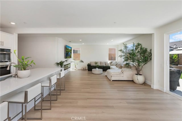 16707 Island Oak St, Fontana, CA 92336 - living room with light wood finished floors and recessed lighting