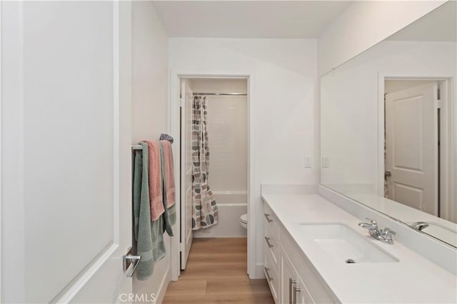 16707 Island Oak St, Fontana, CA 92336 - full bathroom with vanity, wood finished floors, and shower / bath combo with shower curtain