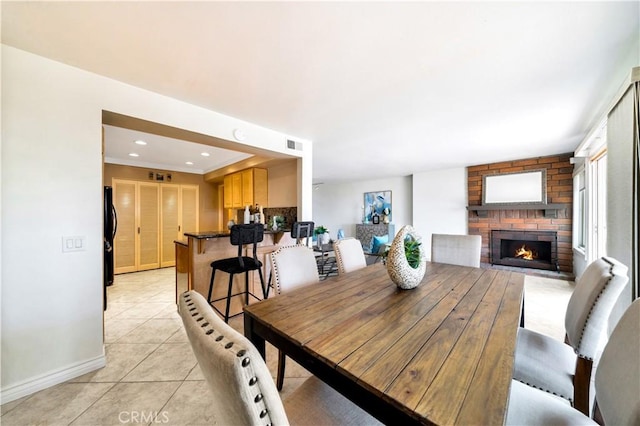15 Vista Del Ponto Unit 70, San Clemente, CA 92672 - dining area with light tile patterned flooring and a fireplace