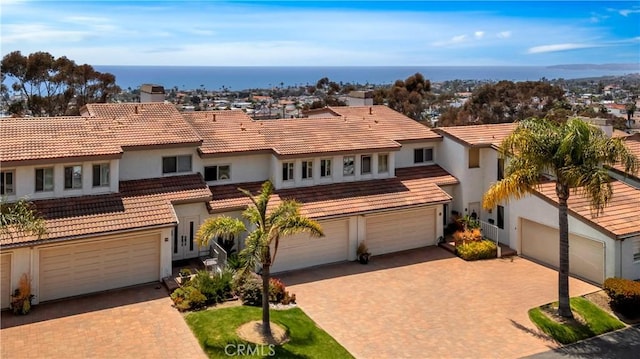 15 Vista Del Ponto Unit 70, San Clemente, CA 92672 - mediterranean / spanish home featuring driveway, a garage, stucco siding, and a tiled roof