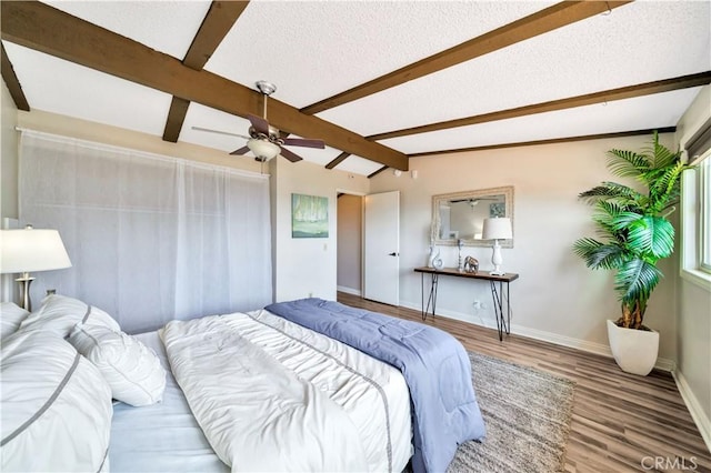 15 Vista Del Ponto Unit 70, San Clemente, CA 92672 - bedroom with wood finished floors, beamed ceiling, a textured ceiling, and ceiling fan