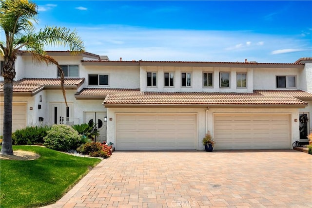 15 Vista Del Ponto Unit 70, San Clemente, CA 92672 - view of front of property with stucco siding, a garage, and decorative driveway