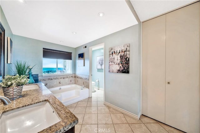 15 Vista Del Ponto Unit 70, San Clemente, CA 92672 - bathroom featuring double vanity, a garden tub, and tile patterned floors