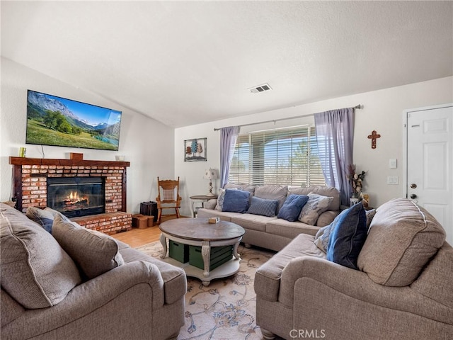 11671 Mountain Rd, Pinon Hills, CA 92372 - living area with lofted ceiling, light wood-style flooring, and a brick fireplace