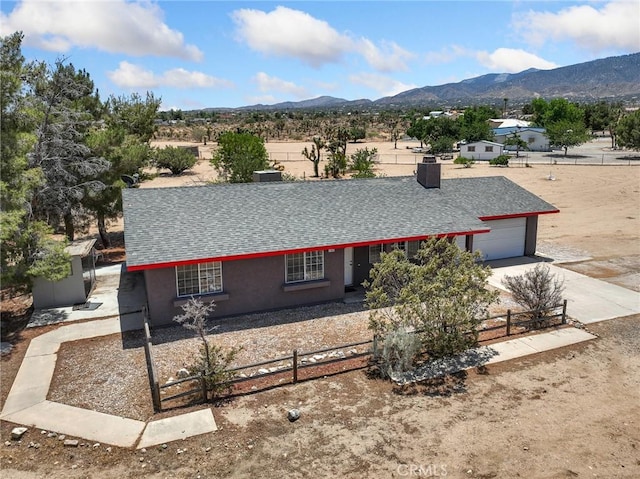 11671 Mountain Rd, Pinon Hills, CA 92372 - ranch-style home featuring a mountain view, roof with shingles, concrete driveway, an attached garage, and stucco siding