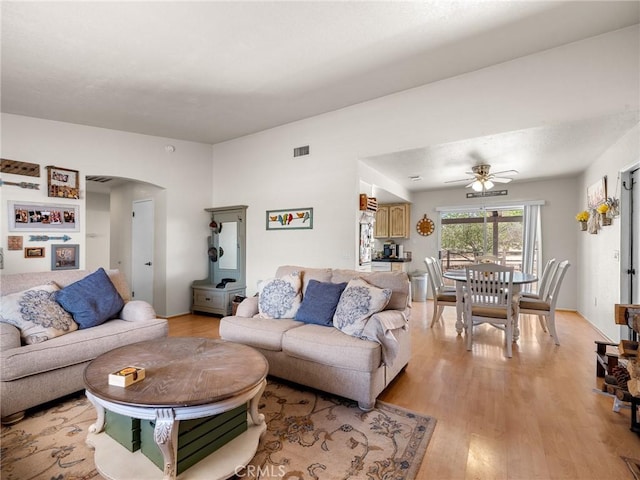 11671 Mountain Rd, Pinon Hills, CA 92372 - living area with arched walkways, light wood-style floors, and a ceiling fan