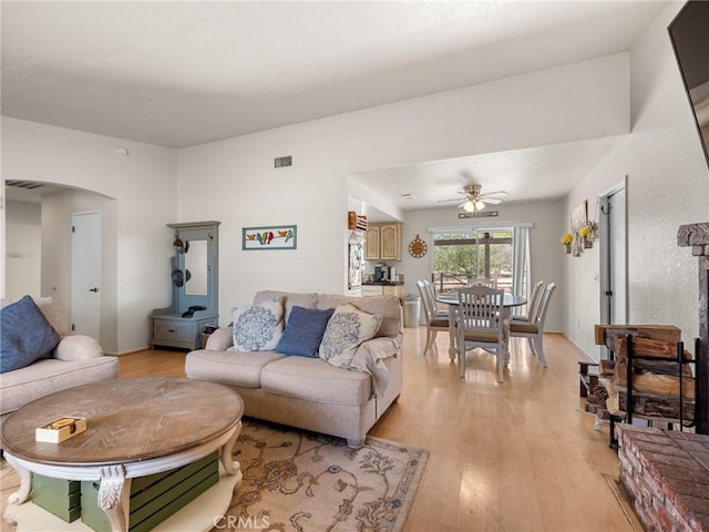 11671 Mountain Rd, Pinon Hills, CA 92372 - living area featuring arched walkways, ceiling fan, and light wood finished floors