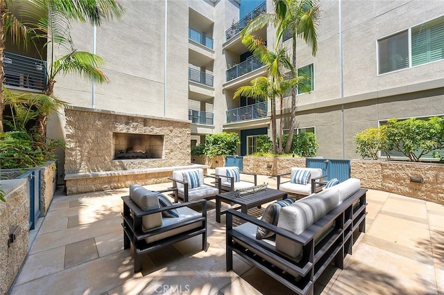 300 E 4th St Unit 118, Long Beach, CA 90802 - view of patio / terrace with an outdoor living space with a fireplace