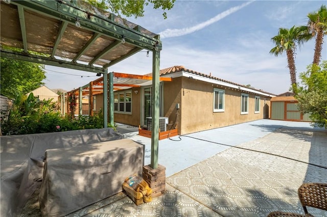 3455 Sugar Maple Ct, Hemet, CA 92545 - back of property featuring a patio area, a pergola, a shed, and stucco siding