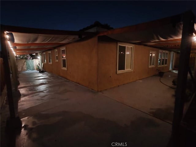 3455 Sugar Maple Ct, Hemet, CA 92545 - property exterior at twilight featuring a patio and stucco siding