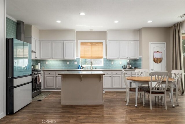 3455 Sugar Maple Ct, Hemet, CA 92545 - kitchen featuring stainless steel range with gas stovetop, fridge, plenty of natural light, white cabinets, and recessed lighting