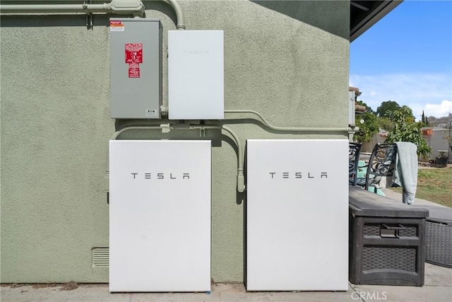 6320 Rancho Rio Rd, Paramount, CA 90723 - exterior view of wall-mounted power storage and stucco siding