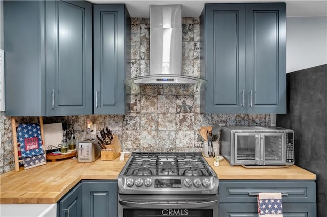 6320 Rancho Rio Rd, Paramount, CA 90723 - kitchen featuring wall chimney exhaust hood, stainless steel range with gas cooktop, butcher block countertops, and decorative backsplash