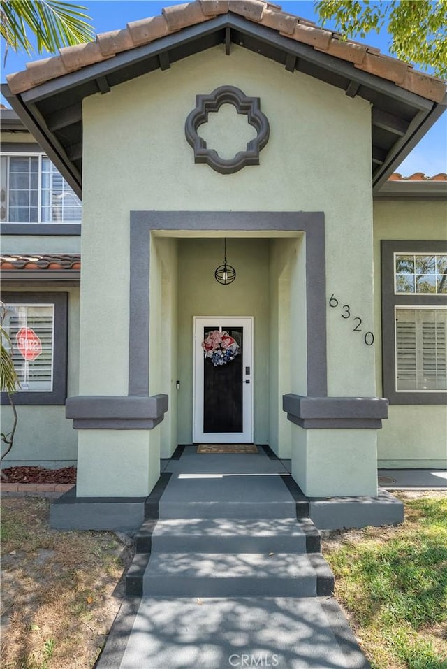 6320 Rancho Rio Rd, Paramount, CA 90723 - entrance to property featuring a tile roof and stucco siding