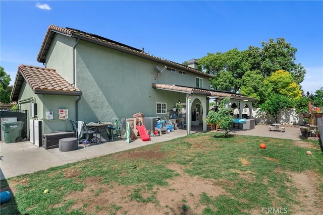 6320 Rancho Rio Rd, Paramount, CA 90723 - rear view of property featuring a patio area, an outdoor living space, a tiled roof, and stucco siding