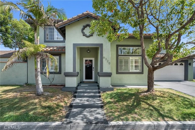 6320 Rancho Rio Rd, Paramount, CA 90723 - mediterranean / spanish home featuring driveway, a tiled roof, stucco siding, a garage, and a front yard