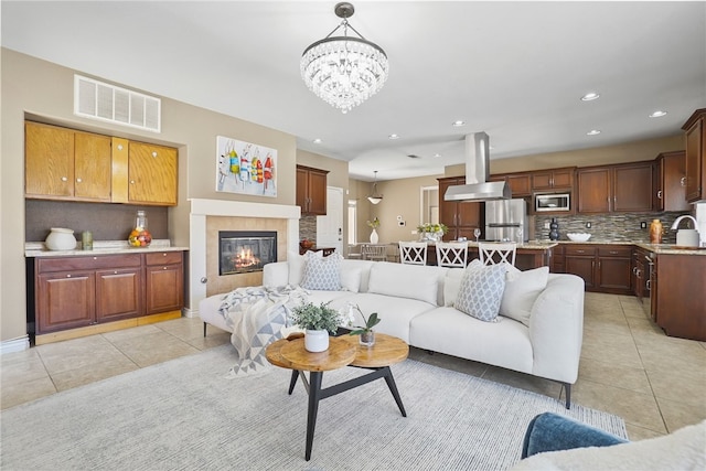 35887 Rhone Ln, Winchester, CA 92596 - living area featuring light tile patterned floors, a chandelier, a tile fireplace, and recessed lighting