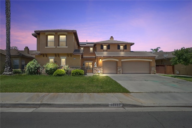 35887 Rhone Ln, Winchester, CA 92596 - view of front facade featuring stucco siding, solar panels, concrete driveway, stone siding, and a garage