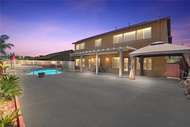 35887 Rhone Ln, Winchester, CA 92596 - back of property at dusk featuring a gazebo, stucco siding, and a patio