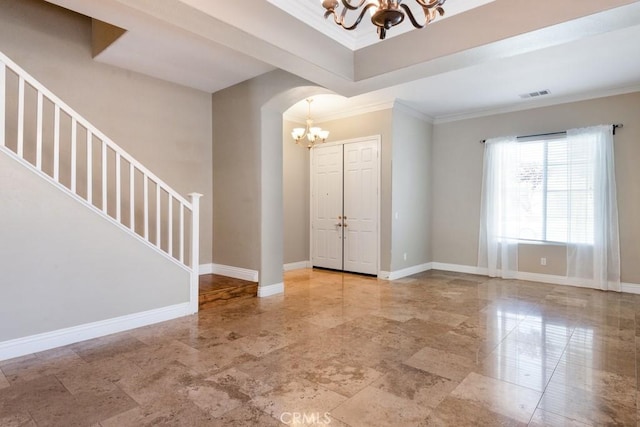34214 Pinehurst Dr, Yucaipa, CA 92399 - entrance foyer with a chandelier, stairs, ornamental molding, and arched walkways