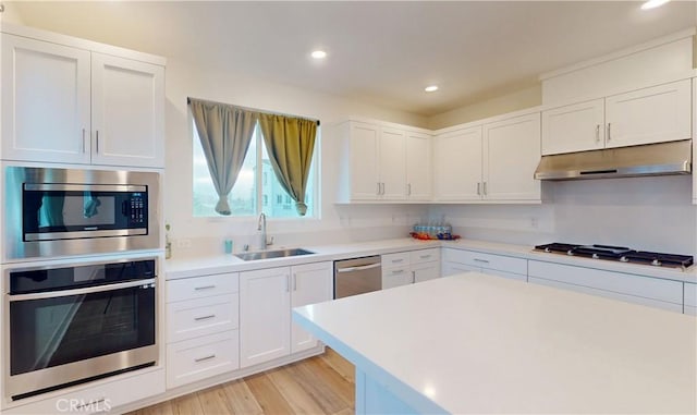 2750 W 182nd St Unit 112, Torrance, CA 90504 - kitchen featuring appliances with stainless steel finishes, under cabinet range hood, light countertops, white cabinets, and recessed lighting