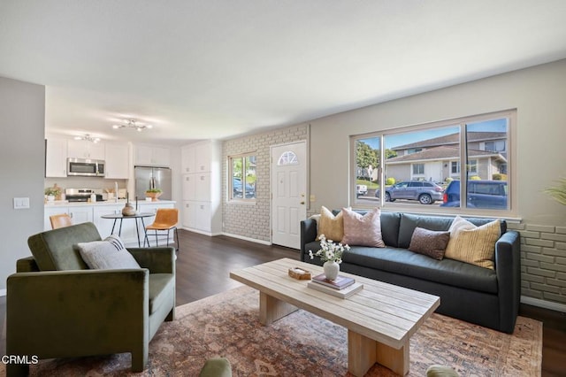 5946 Hickory St Unit 1, Carpinteria, CA 93013 - living area with dark wood-type flooring and brick wall
