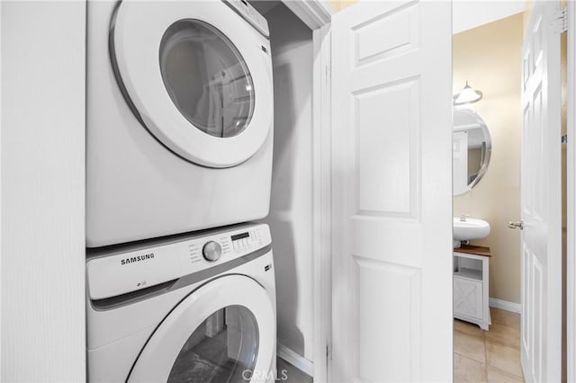 2802 Green River Rd Unit 101, Corona, CA 92882 - laundry area featuring stacked washer / dryer and light tile patterned floors
