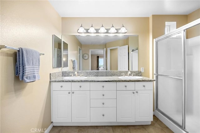 2802 Green River Rd Unit 101, Corona, CA 92882 - bathroom featuring double vanity, a shower stall, and tile patterned flooring