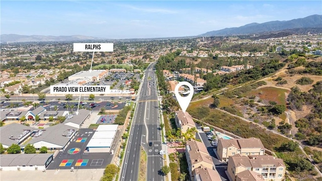 2802 Green River Rd Unit 101, Corona, CA 92882 - aerial view of property and surrounding area featuring mountains and nearby suburban area