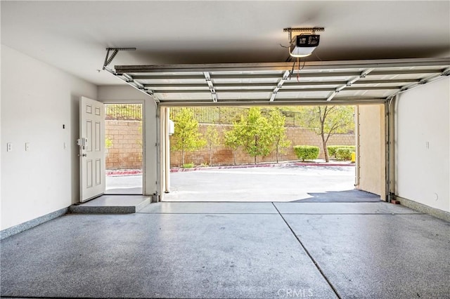 2802 Green River Rd Unit 101, Corona, CA 92882 - garage featuring a garage door opener and baseboards