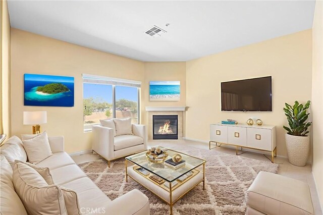 2802 Green River Rd Unit 101, Corona, CA 92882 - living room featuring baseboards and a glass covered fireplace